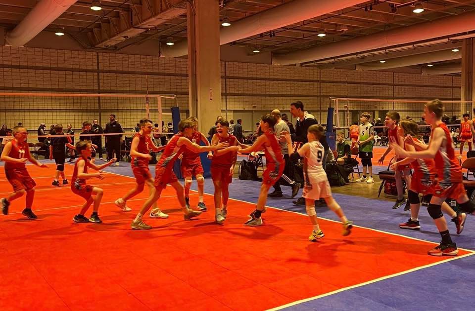 Yorktowne boys volleyball athletes training on an indoor court